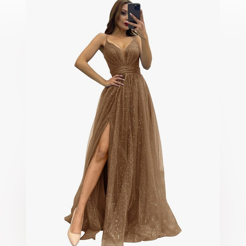 Gold sparkly tulle formal dress with spaghetti straps and slit.